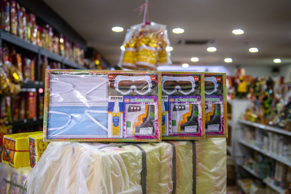 A set of face masks, goggles, hand sanitiser and thermometer, all made of paper, is seen for sale ahead of the Qing Ming festival in Rawang March 22, 2021. u00e2u20acu201d AFP pic