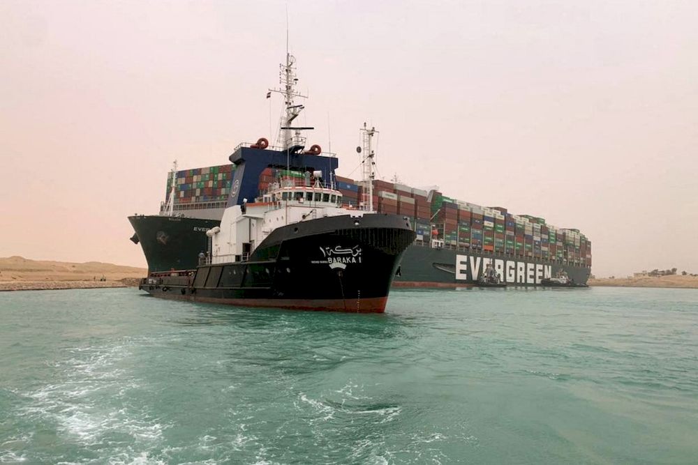 Suez Canal Authority handout picture shows the Panama-flagged MV Ever Given (operated by Taiwan-based Evergreen Marine) being lodged sideways and impeding all traffic across the waterway of Egyptu00e2u20acu2122s Suez Canal, March 24, 2021. u00e2u20acu201d AFP pic