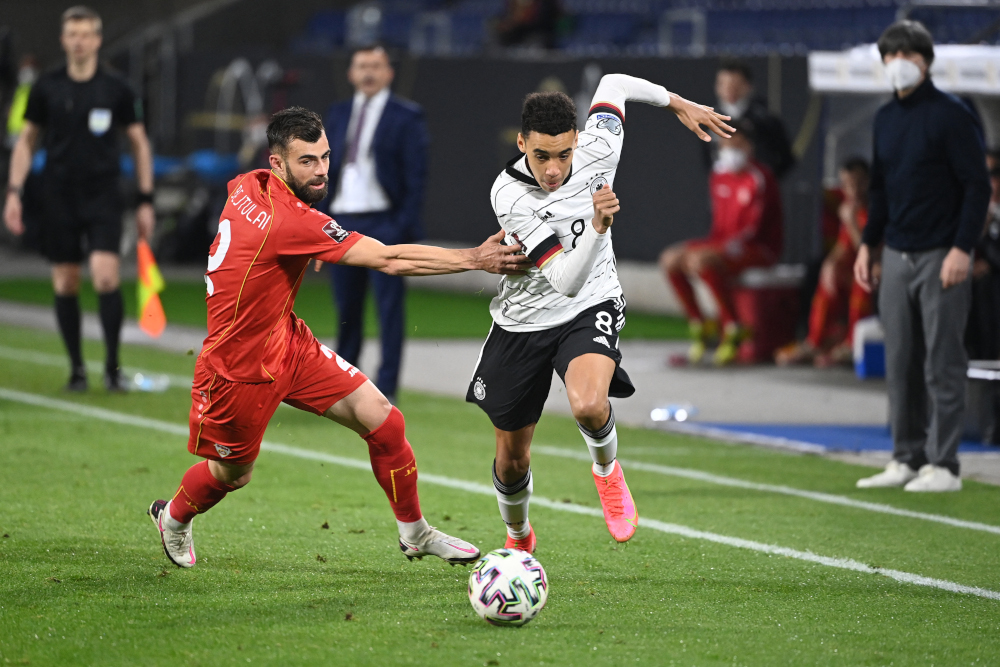 North Macedoniau00e2u20acu2122s defender Egzon Bejtulai and Germanyu00e2u20acu2122s midfielder Jamal Musiala vie for the ball during the Fifa World Cup Qatar 2022 qualification football match in Duisburg, western Germany March 31, 2021. u00e2u20acu201d AFP picnn