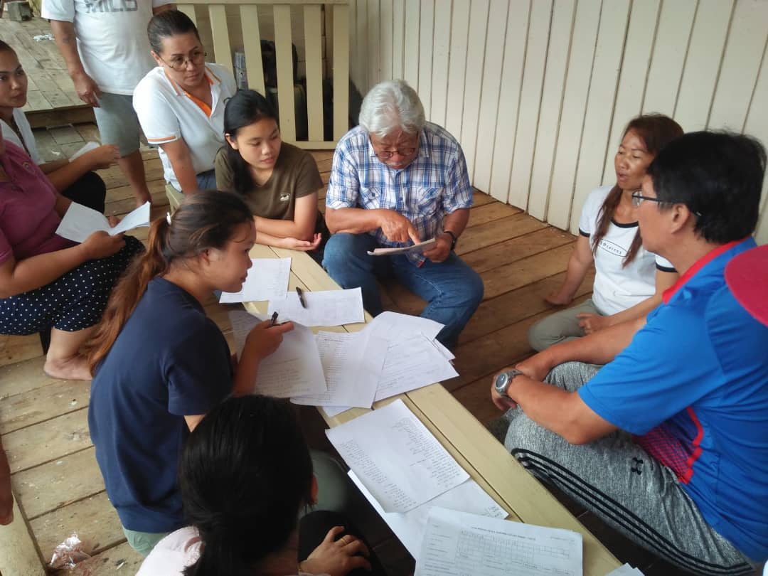 Sarawak Deputy Chief Minister Tan Sri James Masing (seated, centre) helps young residents of Long Singut apply for Malaysian identity documents April 8, 2021. u00e2u20acu201d Picture courtesy of Tan Sri Dr James Masing