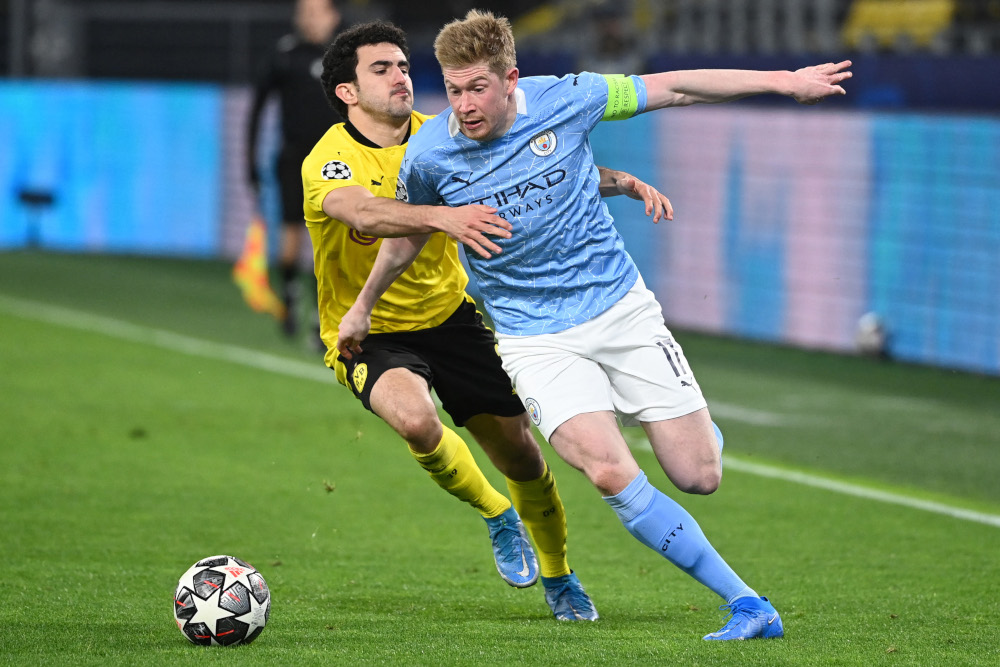 Dortmund defender Mateu Morey and Manchester City midfielder Kevin De Bruyne vie for the ball during the Uefa Champions League quarter-final second leg football match in Dortmund, western Germany, April 14, 2021. u00e2u20acu201d AFP picnn