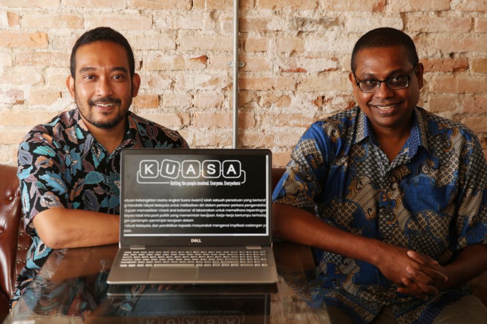 Kuasa chief executive Praba Ganesan (right) and Sharizal Shaarani pose for the cameras during a press conference April 12, 2021. u00e2u20acu201d Picture by Choo Choy Maynn
