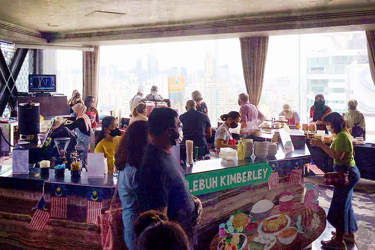 Happy diners wandering from stall to stall, spoilt for choice.