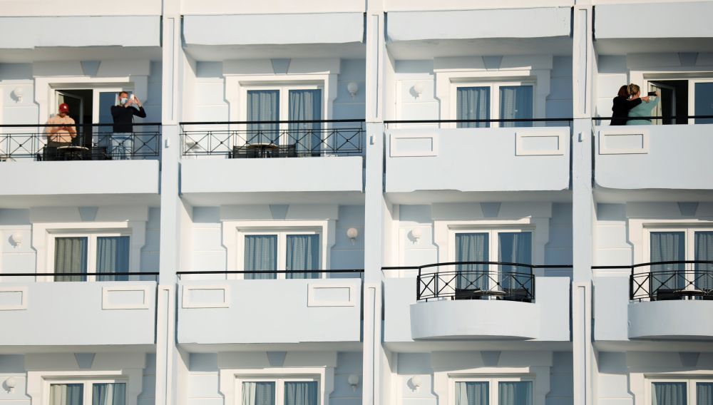 Dutch tourists, who will spend a week long holiday in isolation as part of an experiment, stand on their balconies at the a tourist resort the Mitsis Grand Hotel Beach on the island of Rhodes, Greece April 12, 2021. u00e2u20acu201d Reuters picnn