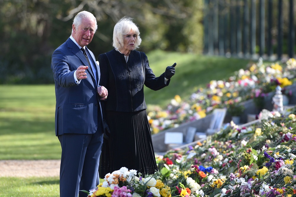 Britain's Prince Charles and Camilla, Duchess of Cornwall, visit the gardens of Marlborough House to view the flowers and messages left by members of the public outside Buckingham Palace in London  April 15, 2021. u00e2u20acu2022 Pool via Reuters