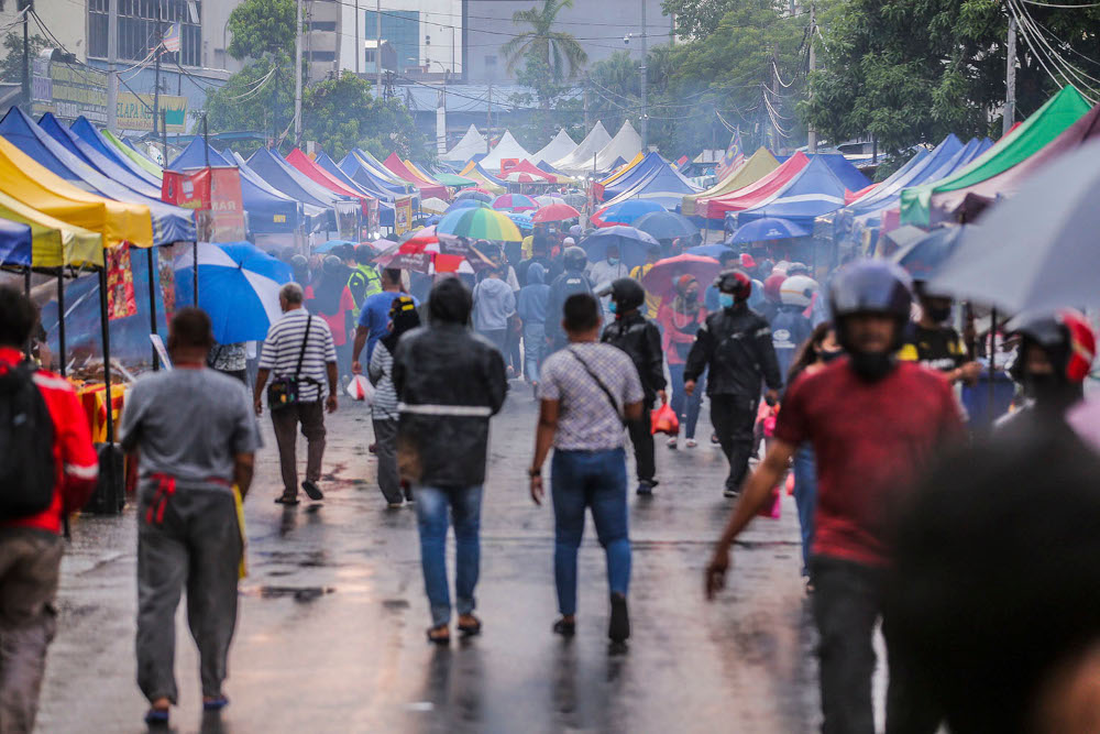 Visitors maintain physical distancing and wear face masks to comply with standard operating procedures (SOP) when visiting the Kampung Baru Ramadan bazaar, April 14, 2021. u00e2u20acu2022 Picture by Hari Anggara