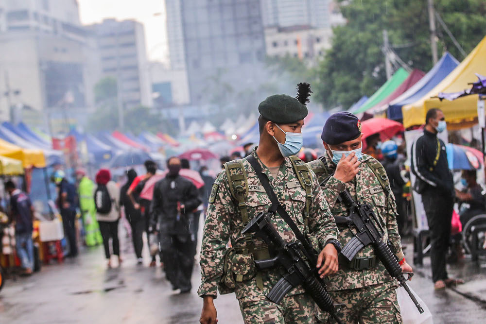 Army personnel ensuring SOP compliance at the Kampung Baru Ramadan bazaar April 14, 2021. u00e2u20acu2022 Picture by Hari Anggara