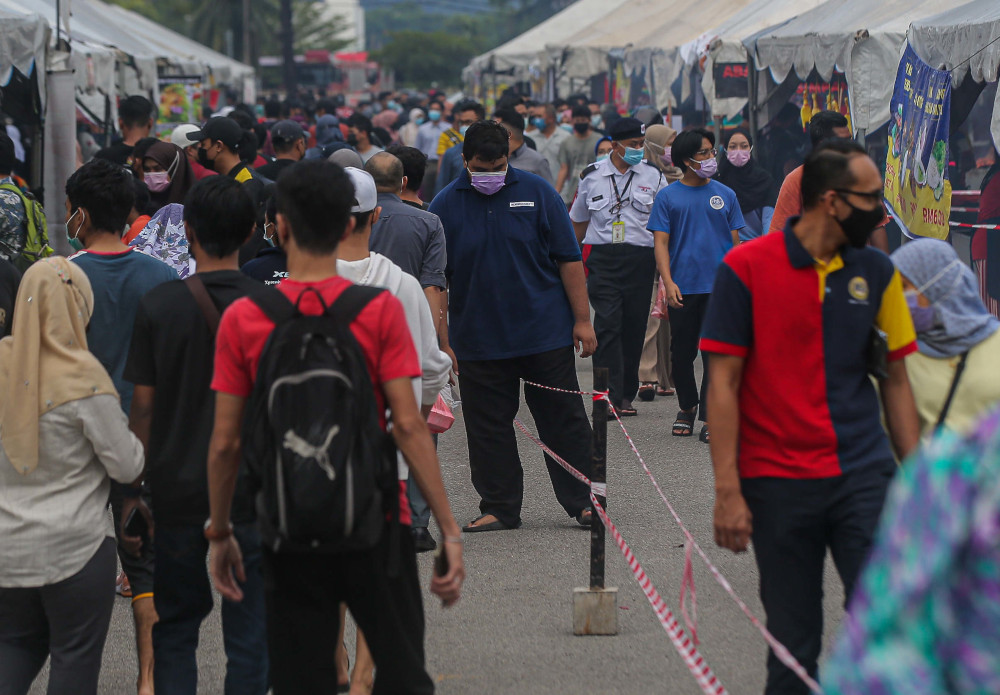 People in Ipoh follow the standard operating procedures (SOP) while purchasing their favourite delicacies at the Ramadan bazaar at Stadium Indera Mulia Car Park, April 15, 2021. u00e2u20acu201d Picture by Farhan Najib