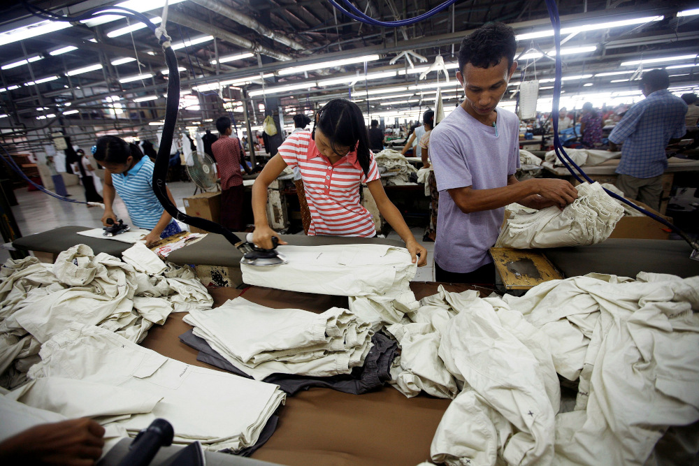 Workers iron and arrange clothing at a garment factory at Hlaing Taryar industrial zone in Yangon in this file picture taken on March 10, 2010. u00e2u20acu201d Reuters pic
