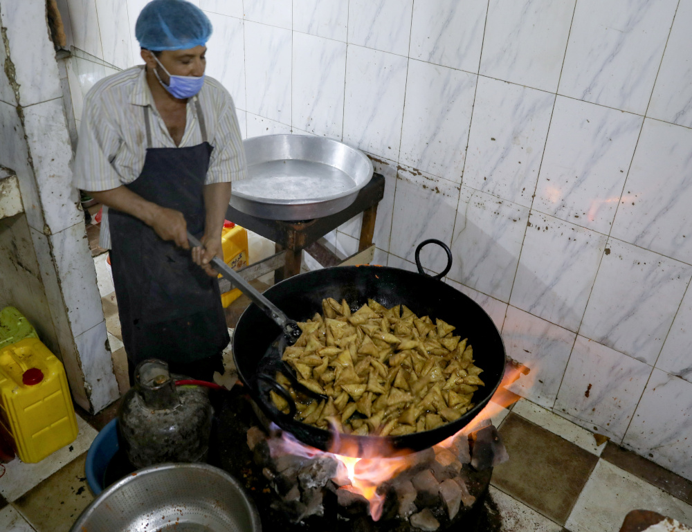 A cook fries sambusa snacks at a restaurant during the holy month of Ramadan in Sanaa April 15, 2021. u00e2u20acu201d Reuters pic