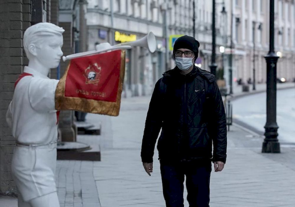 A pedestrian wearing a protective mask walks past a figure of a Young Pioneer, a Soviet-era youth organisation's member, amid the coronavirus disease (Covid-19) outbreak in Moscow, April 15, 2020. u00e2u20acu201d Reuters pic