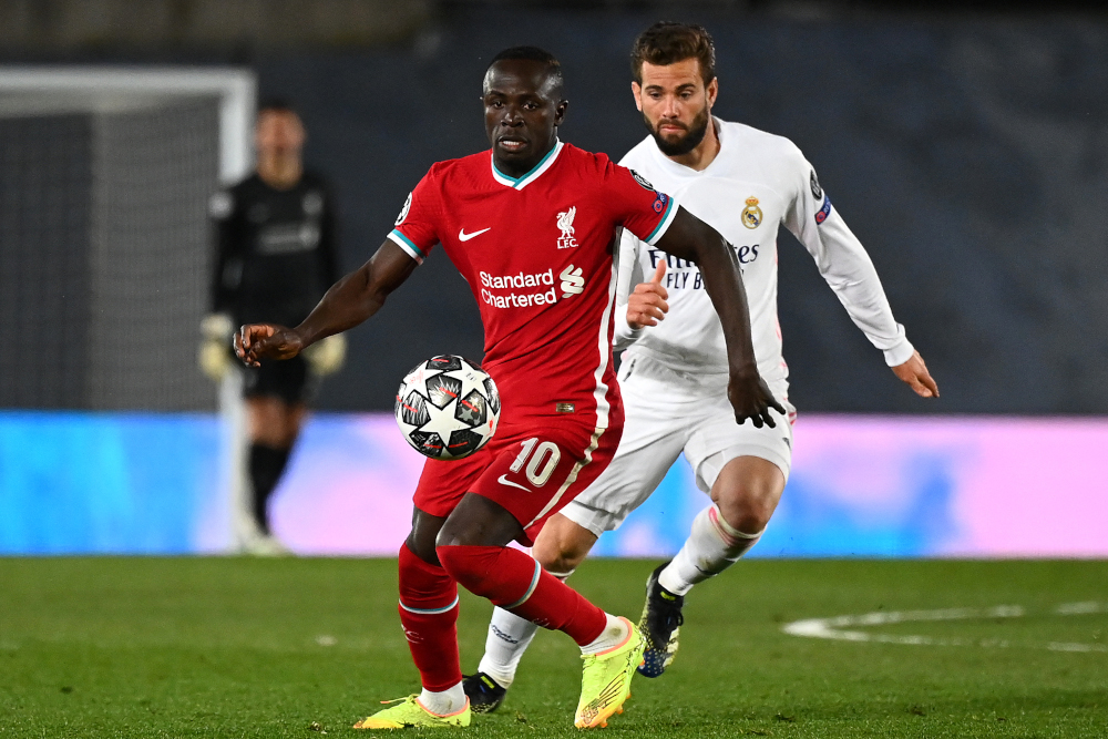 Real Madrid defender Nacho Fernandez (back) challenges Liverpool striker Sadio Mane during the Uefa Champions League first leg quarter-final football match at the Alfredo di Stefano stadium in Valdebebas, April 6, 2021. u00e2u20acu201d AFP picnn