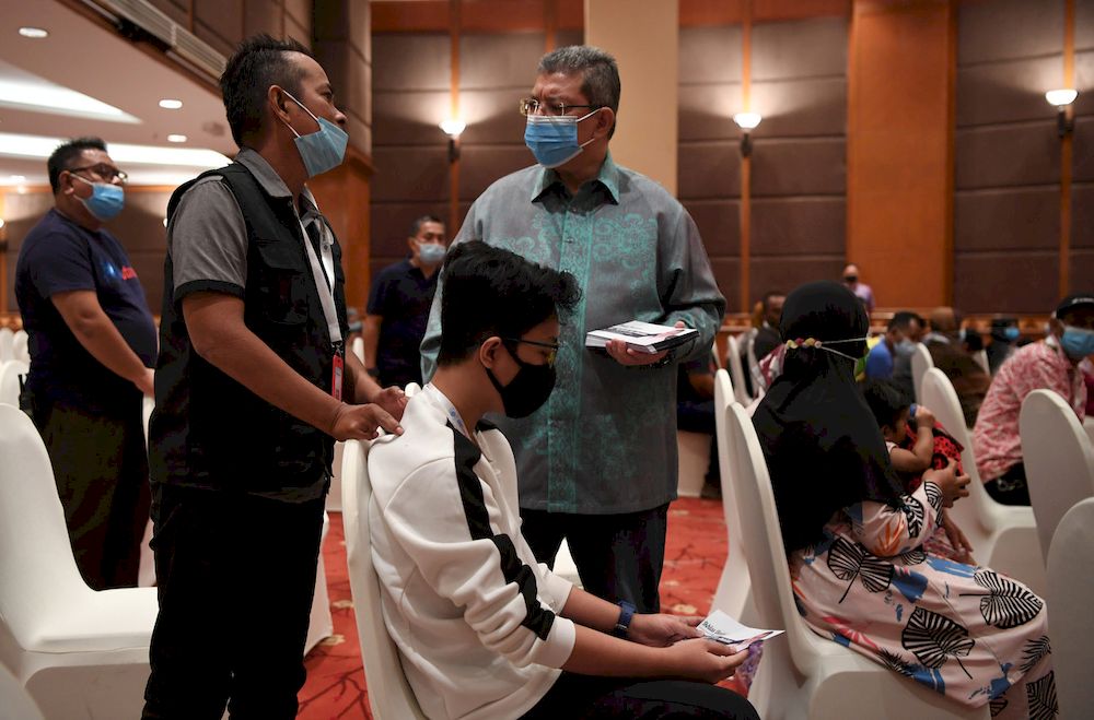 Minister of Communications and Multimedia Datuk Saifuddin Abdullah (right) greeting recipients during the Ramadan Donation Program for people with disabilities (OKU), April 24, 2021 in Kuantan. u00e2u20acu201d Bernama pic