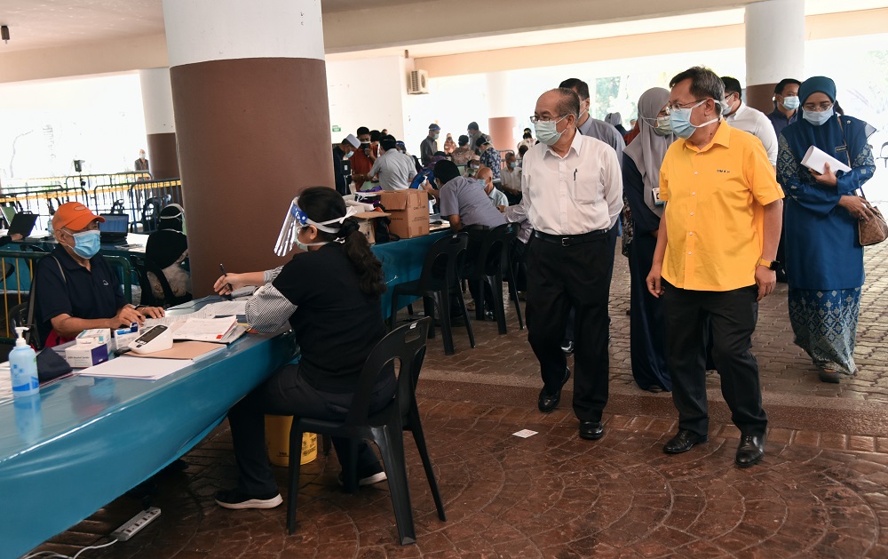 Deputy Chief Minister Datuk Amar Douglas Uggah (second, right) observing the registration process of the vaccination programme at the Indoor Stadium, April 23, 2021. u00e2u20acu2022 Picture courtesy of the state Information Departmentn