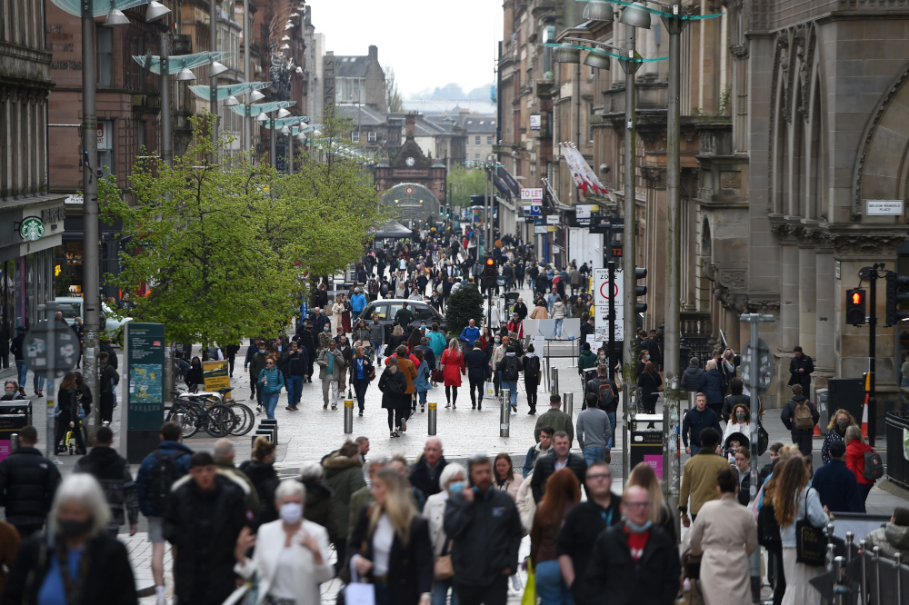Pedestrians walk past re-opened shops and businesses in Glasgow April 26, 2021 following the relaxing of some Covid-19 restrictions in Scotland, after the third national lockdown. u00e2u20acu201d AFP pic 
