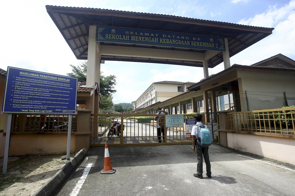 A student being informed by a security guard following the closure of Sekolah Menengah Kebangsaan (SMK) Seremban 2 in line with the recommendation from the District Health Office (PKD) to curb the spread of Covid-19, April 23, 2021. u00e2u20acu201d Bernama pic