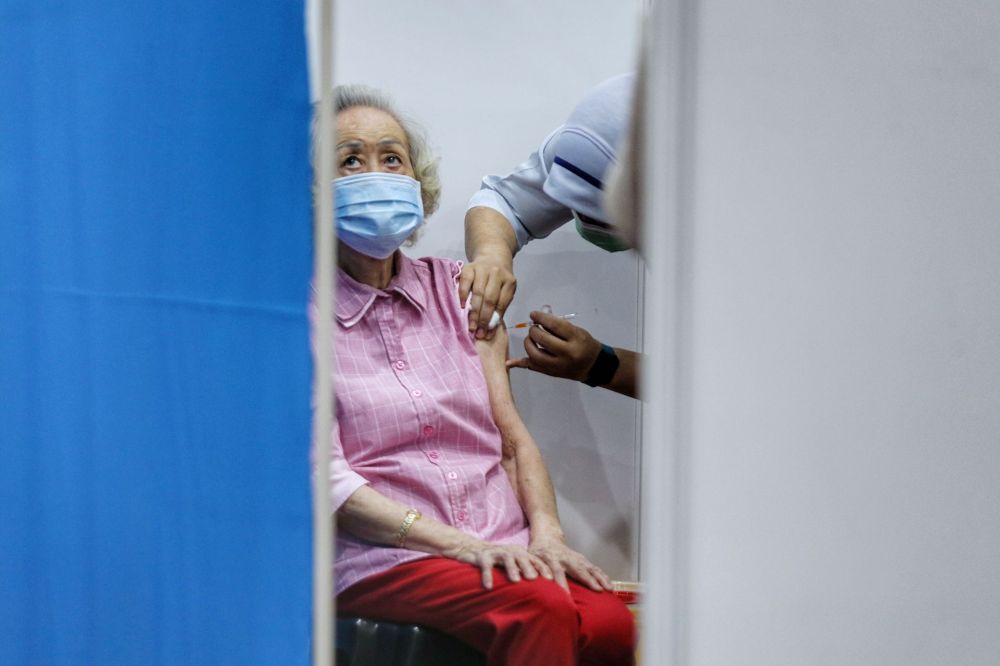 A senior citizen receives her Covid-19 jab at a vaccination centre at the Sunway Pyramid Convention Centre, Petaling Jaya April 27, 2021. u00e2u20acu201d Picture by Ahmad Zamzahuri