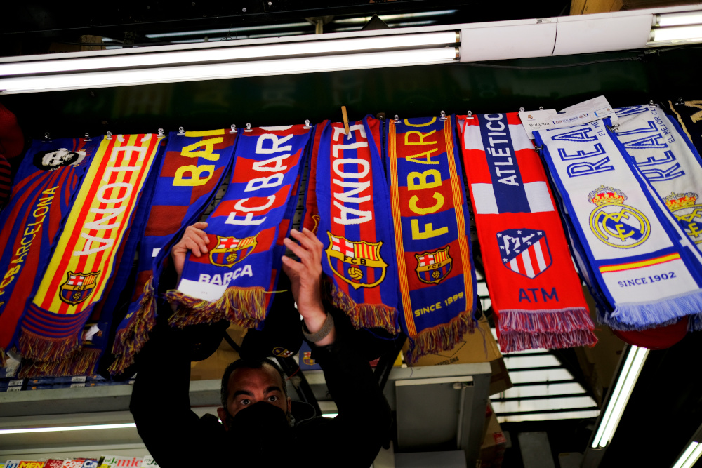Atletico Madrid and Real Madrid scarves are displayed inside a store at Las Ramblas in Barcelona as twelve of Europeu00e2u20acu2122s top football clubs launch a breakaway Super League, April 19, 2021. u00e2u20acu201d Reuters pic 