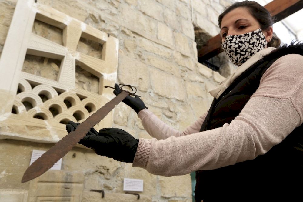 Archaeological officer Elena Stylianou shows a sword thought to be from the period of the crusades, on January 22, 2021, on the site where a chapel of the Knights Templar was built at the Limassol medieval castle. u00e2u20acu201d AFP pic