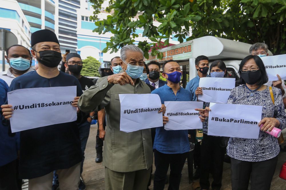 Tun Dr Mahathir Mohamad holds up a sign protesting the delay of Undi18 in front of the Dang Wangi District Police headquarters in Kuala Lumpur April 2, 2021. u00e2u20acu201d Picture by Yusof Mat Isa