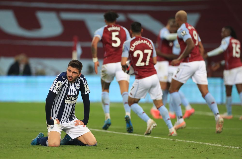 West Bromwich Albion's Okay Yokuslu looks dejected as Aston Villa's Keinan Davis celebrates scoring their second goal with teammates at Villa Park, Birmingham April 25, 2021. u00e2u20acu201d Reuters pic