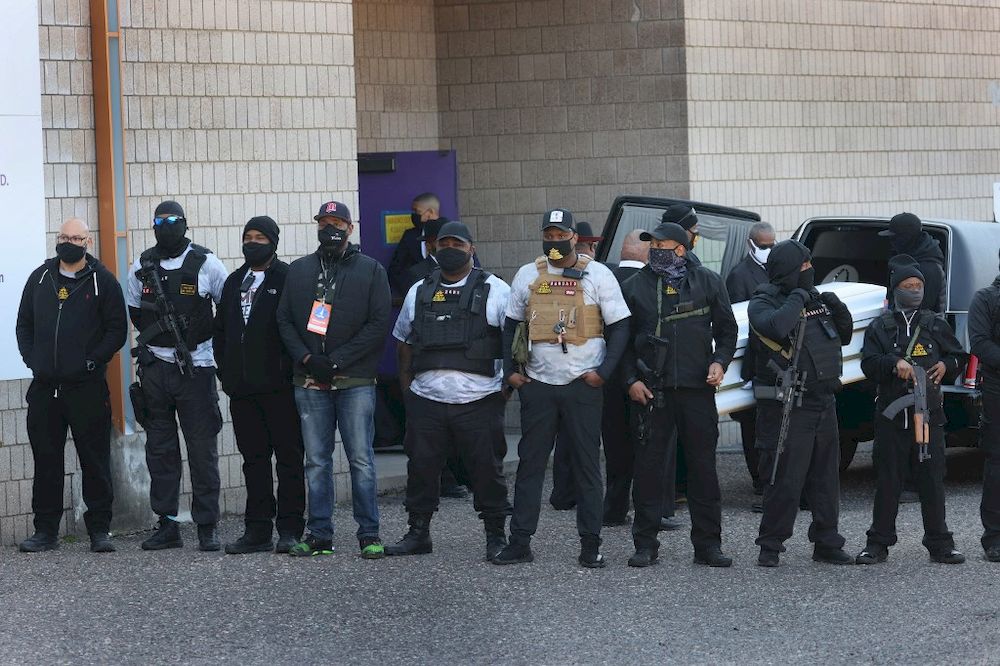 Armed men shield the view of Daunte Wrightu00e2u20acu2122s casket arriving at Shiloh Temple International Ministries for his funeral service on April 22, 2021 in Minneapolis, Minnesota. u00e2u20acu201d Getty Images via AFP