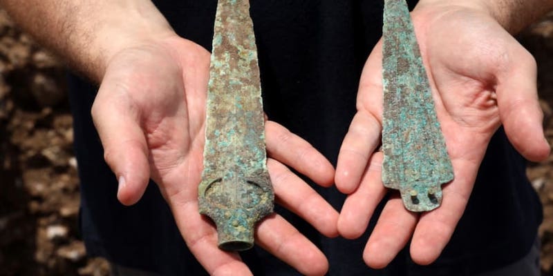 Archeologist of the Israel Antiquities Authority Jacob Vardi holds on July 16, 2019, a bronze head spear and a dagger's blade dated to the middle bronze period. u00e2u20acu201d AFP pic