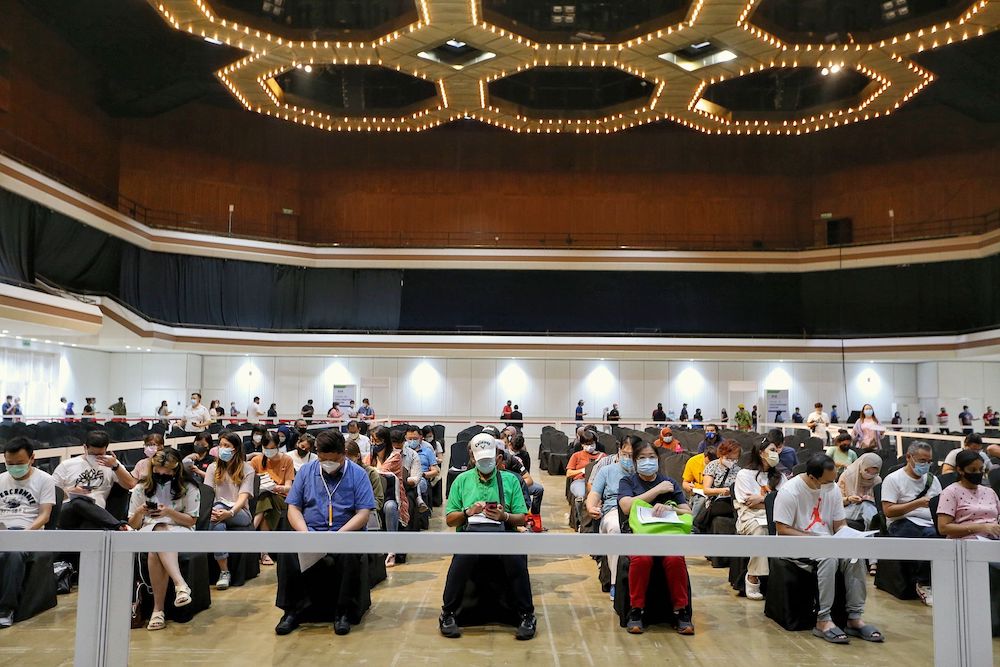 Thousands of people wait to receive their first dose of the AstraZeneca vaccine at World Trade Centre in Kuala Lumpur May 15, 2021. — Picture by Ahmad Zamzahuri