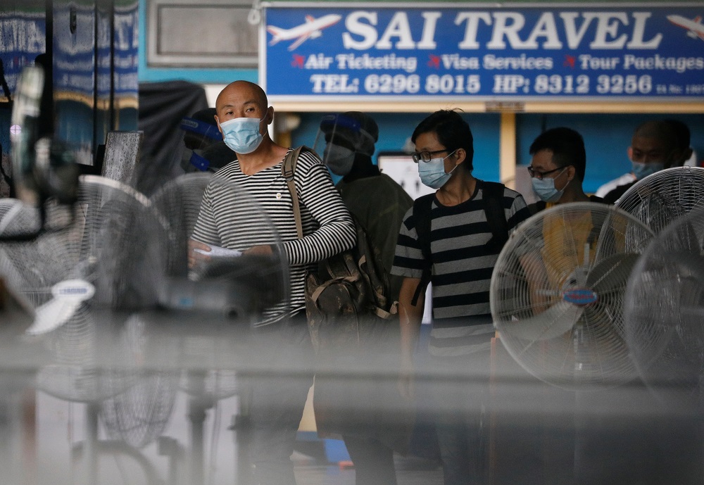 Migrant workers board a bus to leave for a government quarantine facility after workers were tested positive for the coronavirus disease at Westlite Woodlands dormitory in Singapore April 22, 2021. u00e2u20acu201d Reuters pic