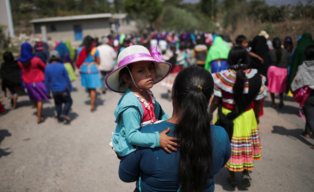 A woman carries a child during a demonstration demanding justice and stop the violence in the communities during a march on the streets of Alcozacan, Guerrero state, Mexico April 30, 2021. u00e2u20acu201d Reuters pic