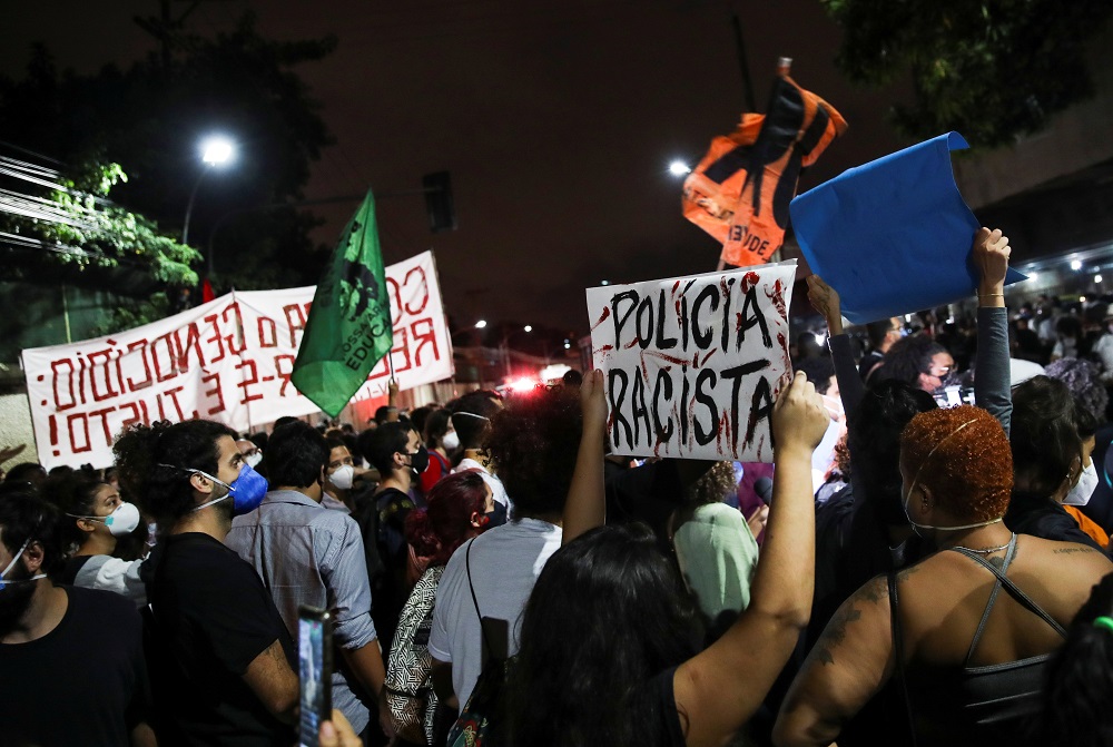 A person holds a banner reading u00e2u20acu02dcracist policeu00e2u20acu2122 during a protest against police violence outside Jacarezinho slum, after a police operation which resulted in 25 deaths, in Rio de Janeiro May 7, 2021. u00e2u20acu201d Reuters pic