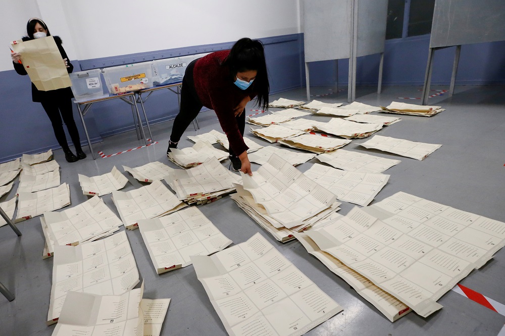 Poll workers sort through and count the votes after polls closed during the elections for governors, mayors, councillors and constitutional assembly members to draft a new constitution to replace Chileu00e2u20acu2122s charter, in Valparaiso, Chile May 16, 2021. u00e2u20acu201d R