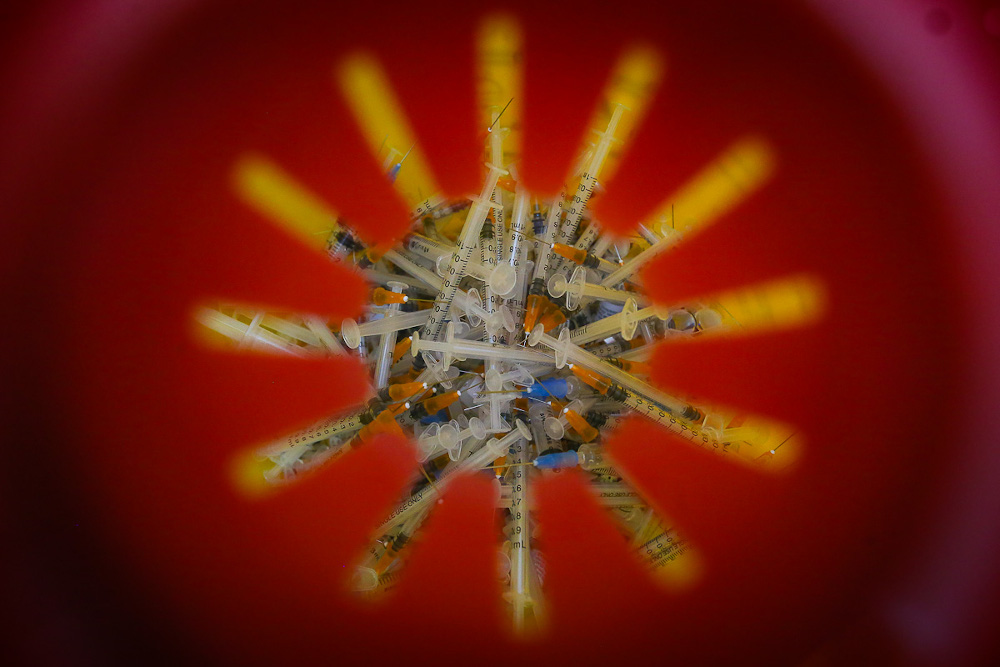 Used syringes are seen in a waste box after being used for Pfizer-BioNTech Covid-19 jab during the National Covid-19 Immunisation Programme at Dewan Kompleks Sukan Pandamaran in Klang May 7, 2021. u00e2u20acu201d Picture by Yusof Mat Isa 