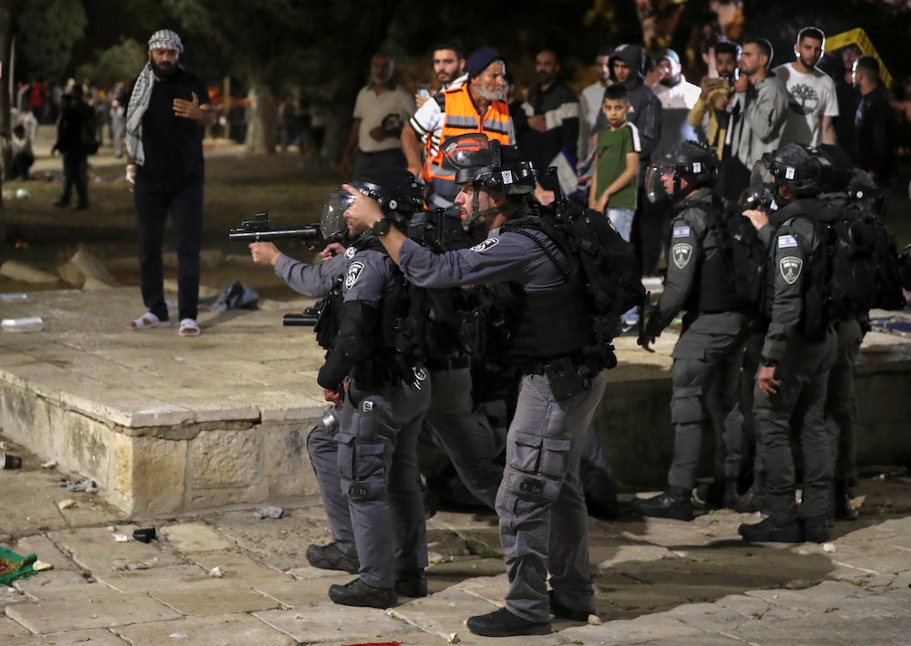 An Israeli policeman gestures as others aim their weapons during clashes with Palestinians a at the compound that houses Al-Aqsa Mosque, in Jerusalem's Old City, May 7, 2021. u00e2u20acu201d Reuters pic 