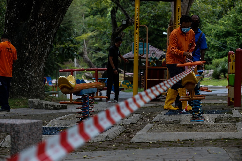 Penang Island City Council personnel cordon off an area within the Penang Youth Park May 10, 2021. u00e2u20acu201d Picture by Sayuti Zainudin