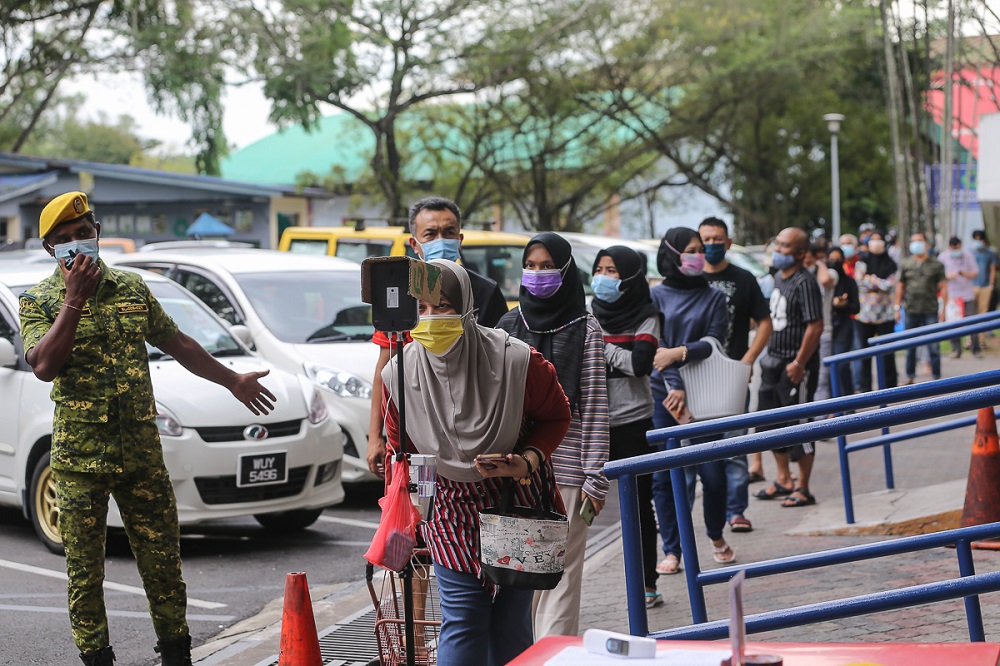 People practice social distancing as they wait in line to enter the Seksyen 6 wet market in Shah Alam May 11, 2021. u00e2u20acu201d Picture by Yusof Mat Isa