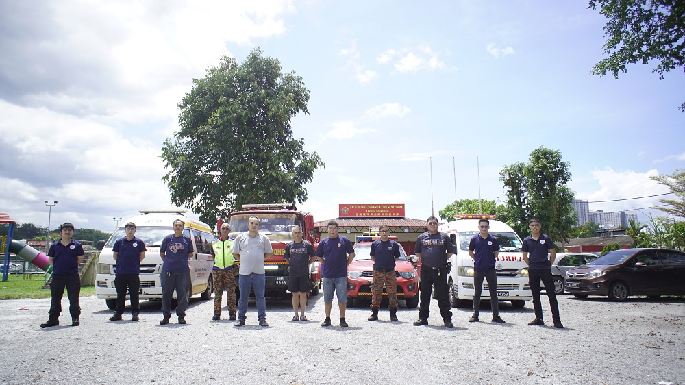 The members of the Pasukan Bomba Sukarela Kepong (PBSK) pose for a photograph in front of their station. — Picture by Arif Zikri 