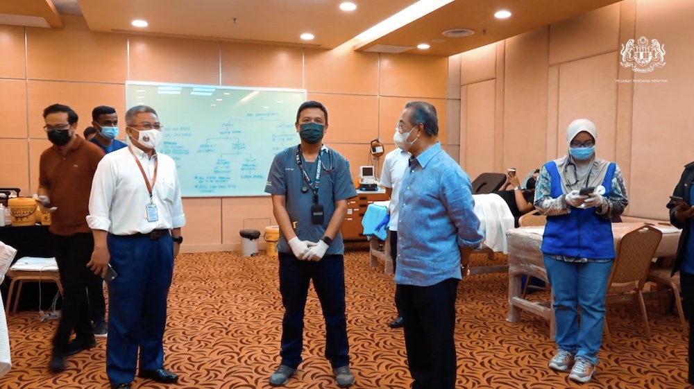 Tan Sri Muhyiddin Yassin visited the vaccine centre along with Datuk Seri Dr Adham Baba. u00e2u20acu201d Facebook video screenshot/Muhyiddin Yassin