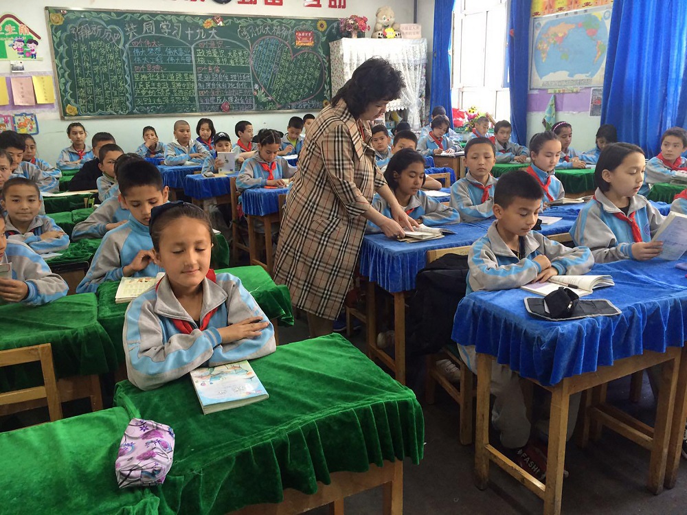 This handout photo taken in May 2016 and received courtesy of Qelbinur Sedik shows Qelbinur Sedik (centre) teaching at a school in Urumqi, in China's western Xinjiang region. u00e2u20acu201d AFP pic