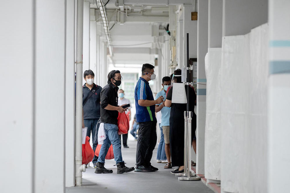 Residents living at Block 506 Hougang Avenue 8 queuing for a Covid-19 swab test at the blocku00e2u20acu2122s void deck on May 21, 2021. u00e2u20acu201d TODAY pic