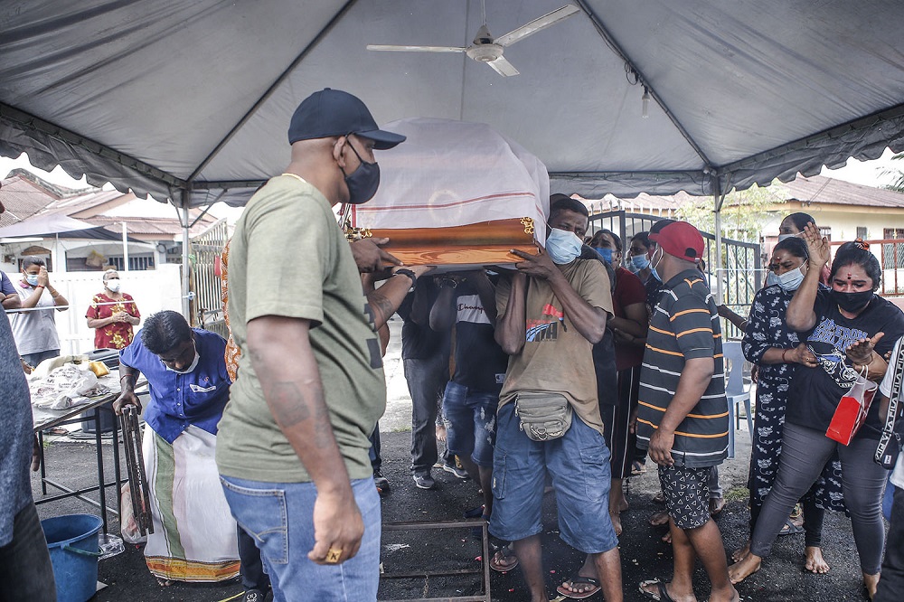 Pallbearers carry a coffin containing the remains of Sivabalan Subramaniam.