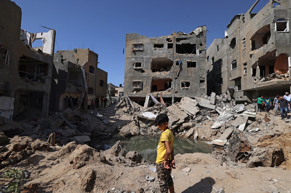 A Palestinian child stands amidst the rubble of buildings, destroyed by Israeli strikes, in Beit Hanun in the northern Gaza Strip May 21, 2021. u00e2u20acu201d AFP pic