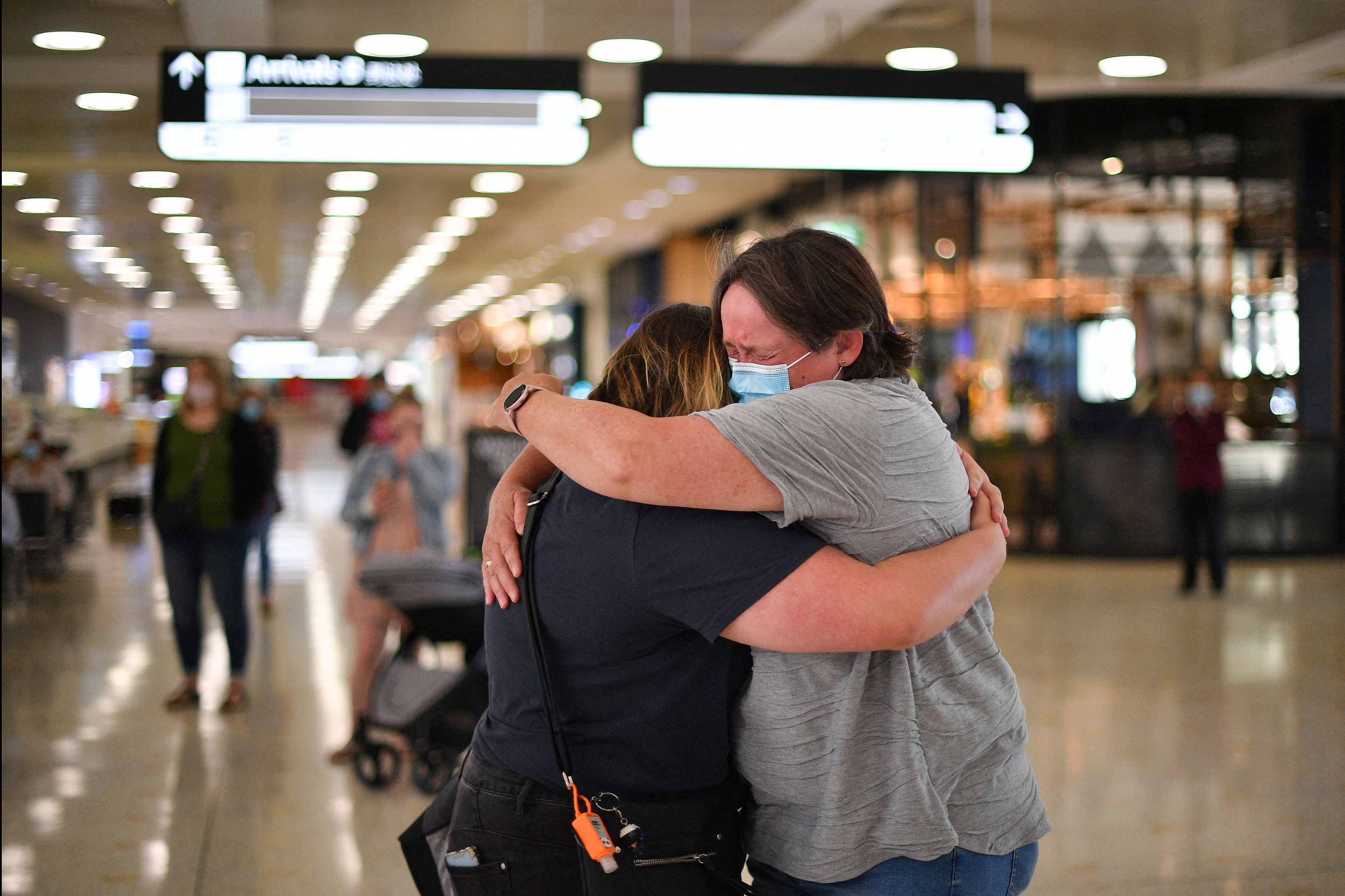 A mother (right) embraces her daughter upon her arrival from New Zealand at Sydney International Airport. u00e2u20acu201d AFP pic