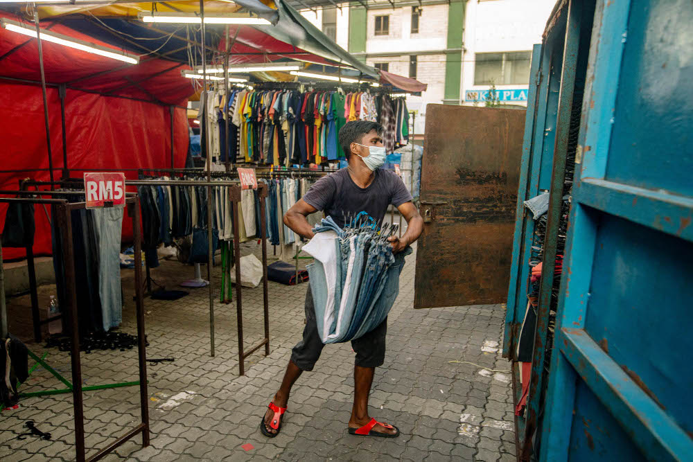 Shopkeepers close their stores in preparation for the the two-week movement control order (MCO) from June 1 to June 14 in Kuala Lumpur May 31, 2021. u00e2u20acu201d Picture by Firdaus Latif