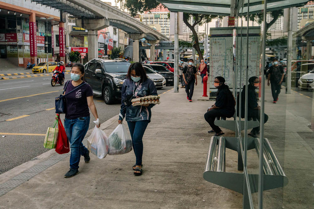 People wearing protective masks walk at Chow Kit in Kuala Lumpur May 31, 2021. u00e2u20acu201d Picture by Firdaus Latif