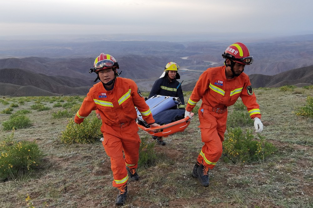 This photo taken on May 22, 2021 shows rescuers carrying equipment as they search for runners who were competing in a 100 km cross-country mountain race when extreme weather hit the area, near the city of. u00e2u20acu201d AFP pic