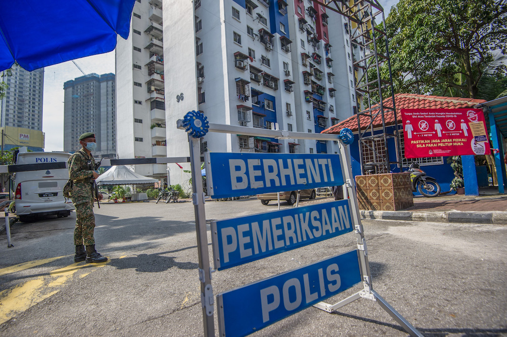 An Armed Forces personnel stands guard in the vicinity of the PPR Kampung Limau in Kuala Lumpur May 23, 2021. u00e2u20acu201d Picture by Shafwan Zaidon