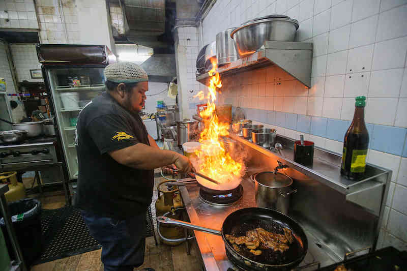 Cooking up a storm. Between suspended meals and the food bank, Konda Kondi is doing its bit for the community. u00e2u20acu201d Picture by Farhan Najib