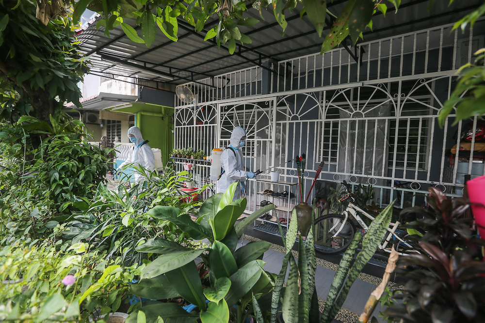 Firefighters wearing protective suits disinfect Flat Proton at Section 27 in Shah Alam May 29, 2021. u00e2u20acu201d Picture by Yusof Mat Isa