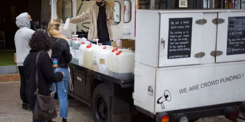 Founder of Topup Truck, Ella Shone serves a customer from her electric milk float converted into a zero waste shop. u00e2u20acu201d AFP pic